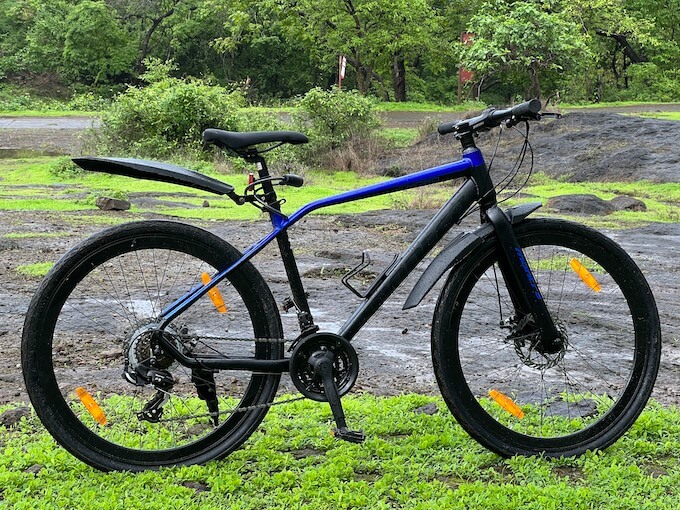 Cyclist enjoying a peaceful ride around Sanjay gandhi National Park, with picturesque views of the lake and green landscapes.